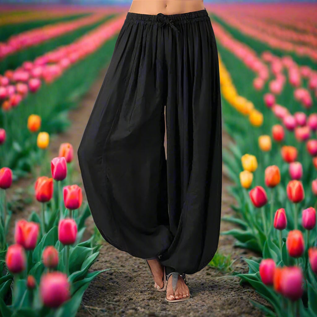 Black wide-leg pants on a plain background