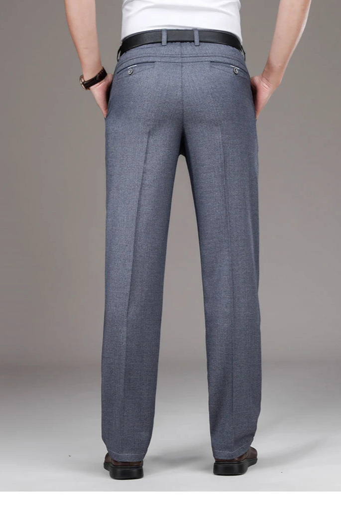 Person wearing gray dress pants on a plain background