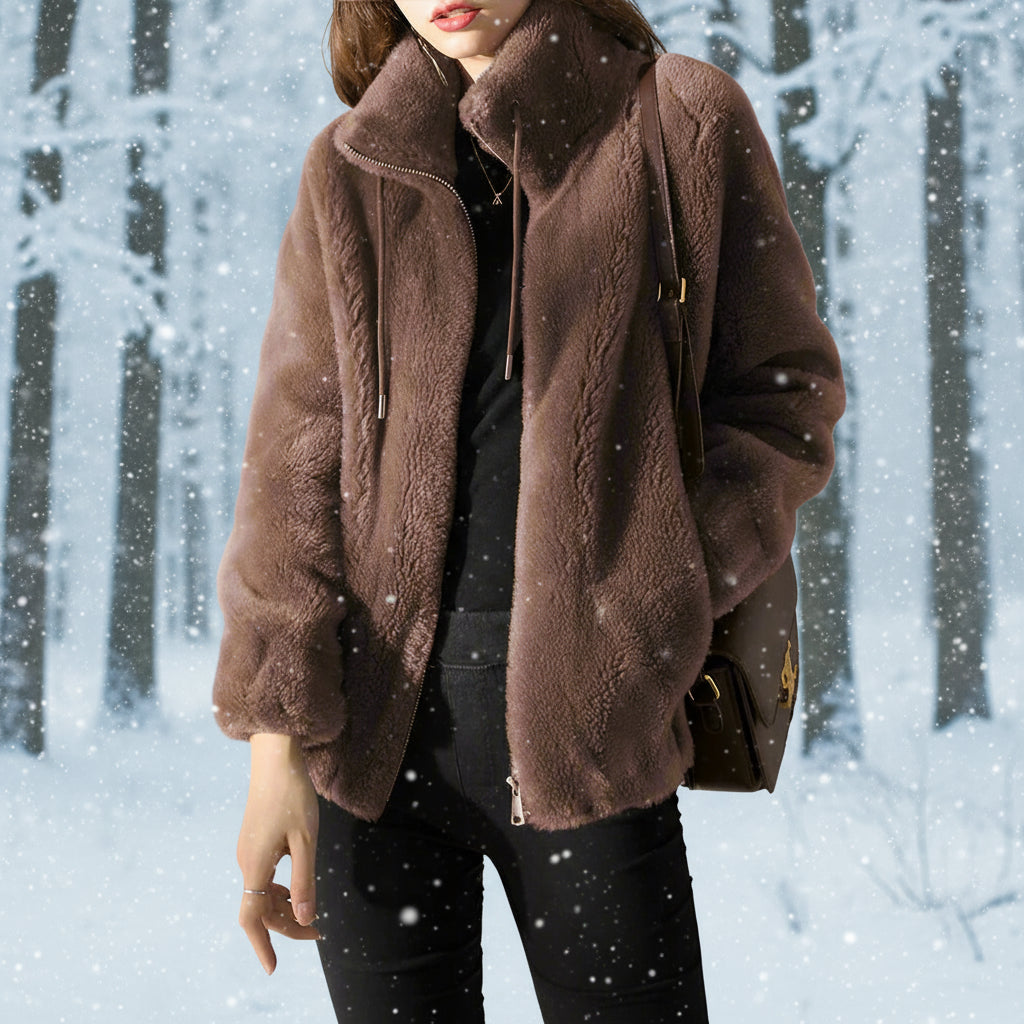 Person wearing a brown textured jacket against a light gray background