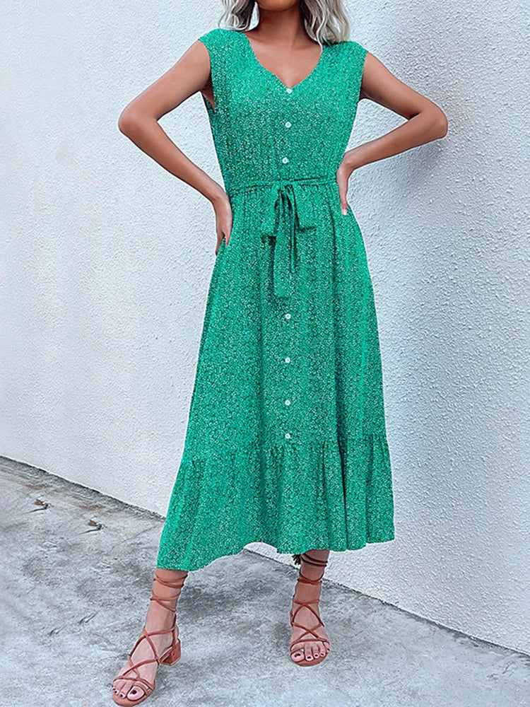 Woman wearing a green dress against a white wall