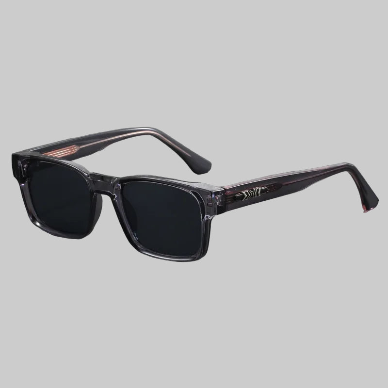 Sunglasses with black lenses and clear frame on a gray background