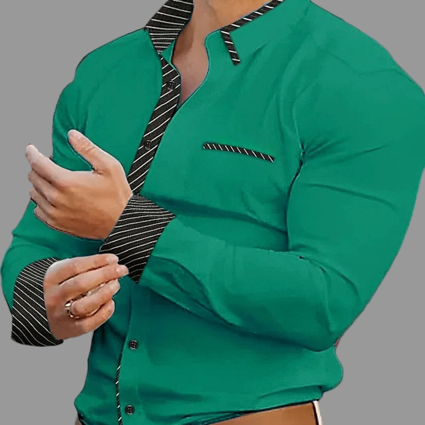 Green shirt with black striped collar and cuffs worn by a person, blurred background