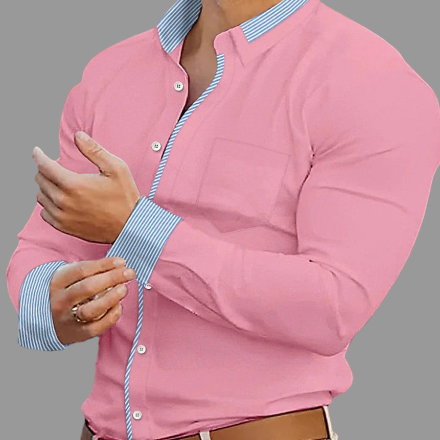 Person wearing a pink jacket with a blurred indoor background
