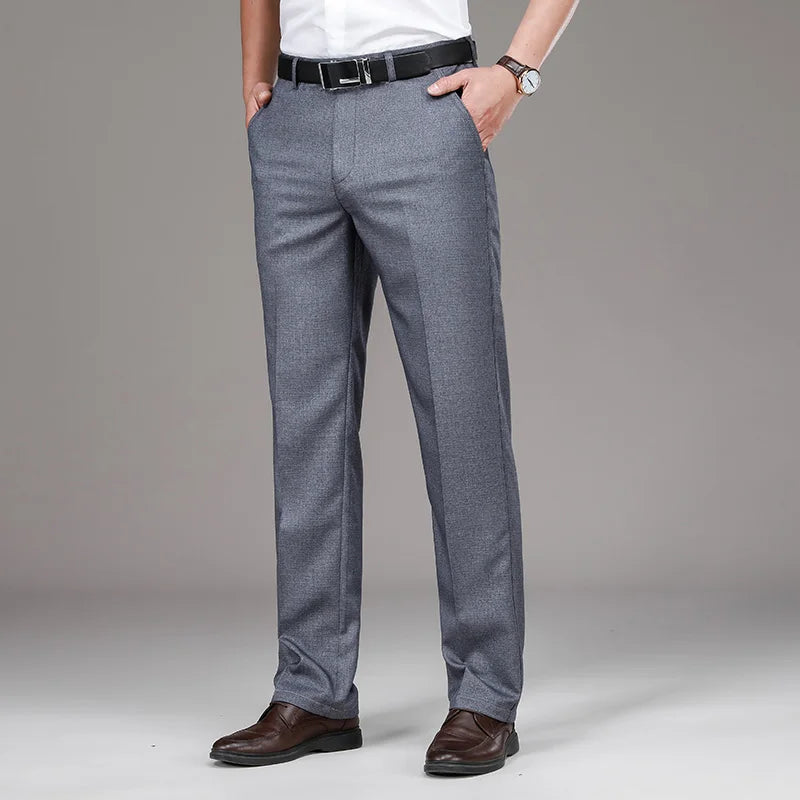 Gray dress pants worn by a person on a plain background