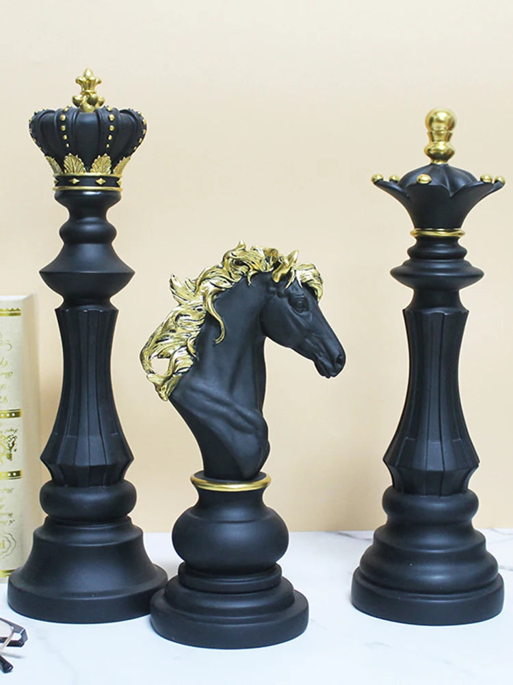 Black and gold chess pieces including a king, queen, and horse on a beige background