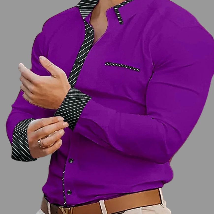 Man wearing a purple shirt with black and white striped collar and cuffs, blurred background