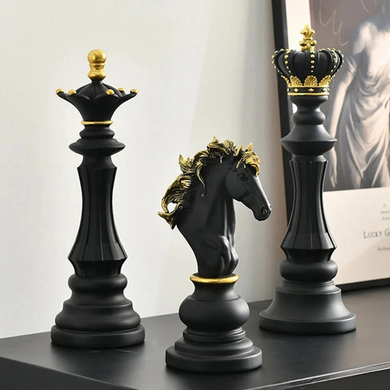 Decorative chess pieces with crowns on a surface