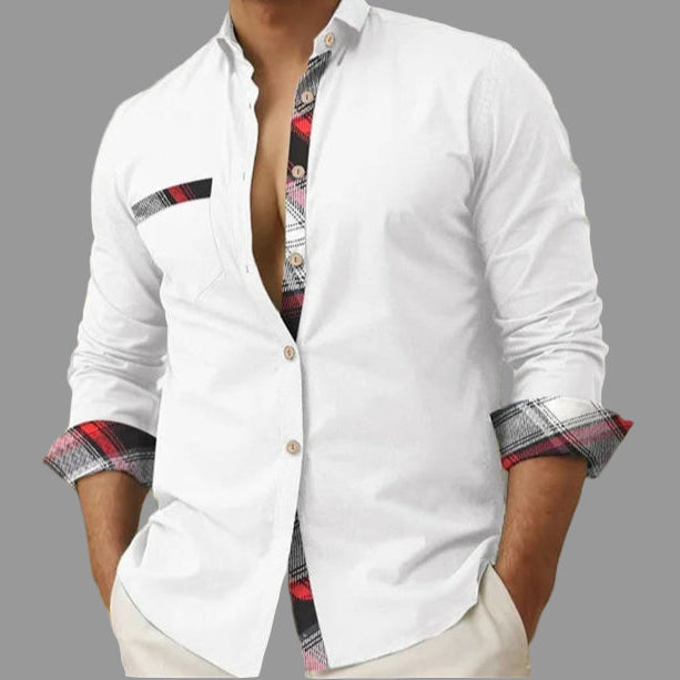 White shirt with plaid cuffs and trim worn by a person, blurred background