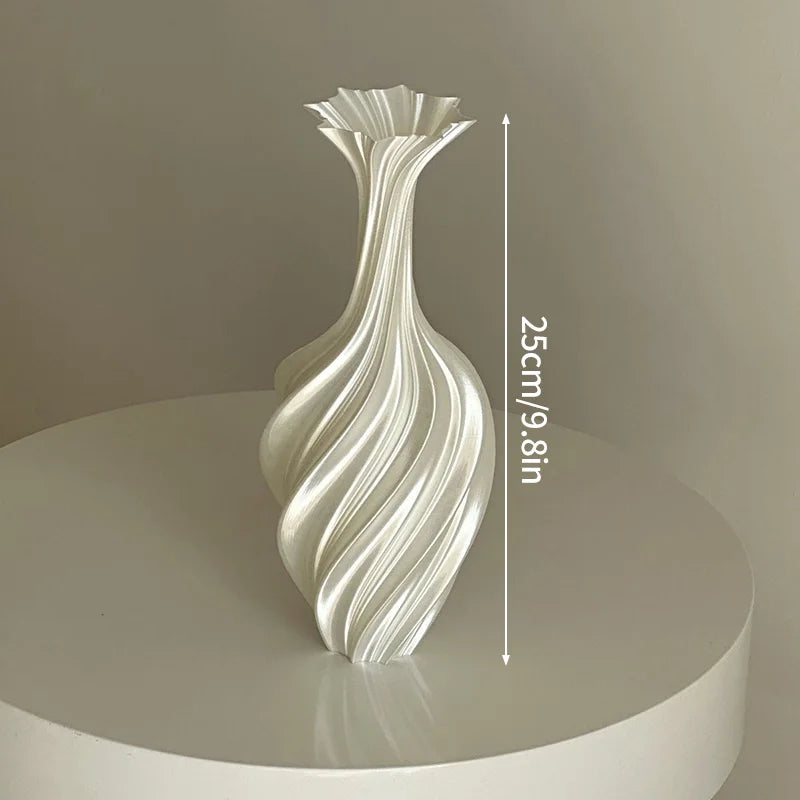 Decorative vase with wavy design on a round platform against a plain background