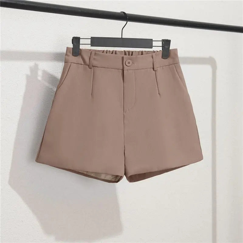 Brown shorts on a hanger against a white background