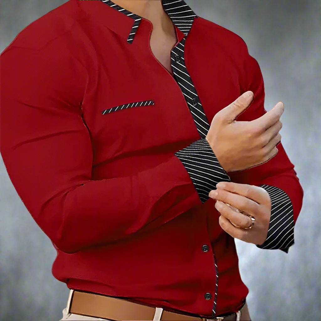 Red shirt with striped collar and cuffs worn by a person, blurred background