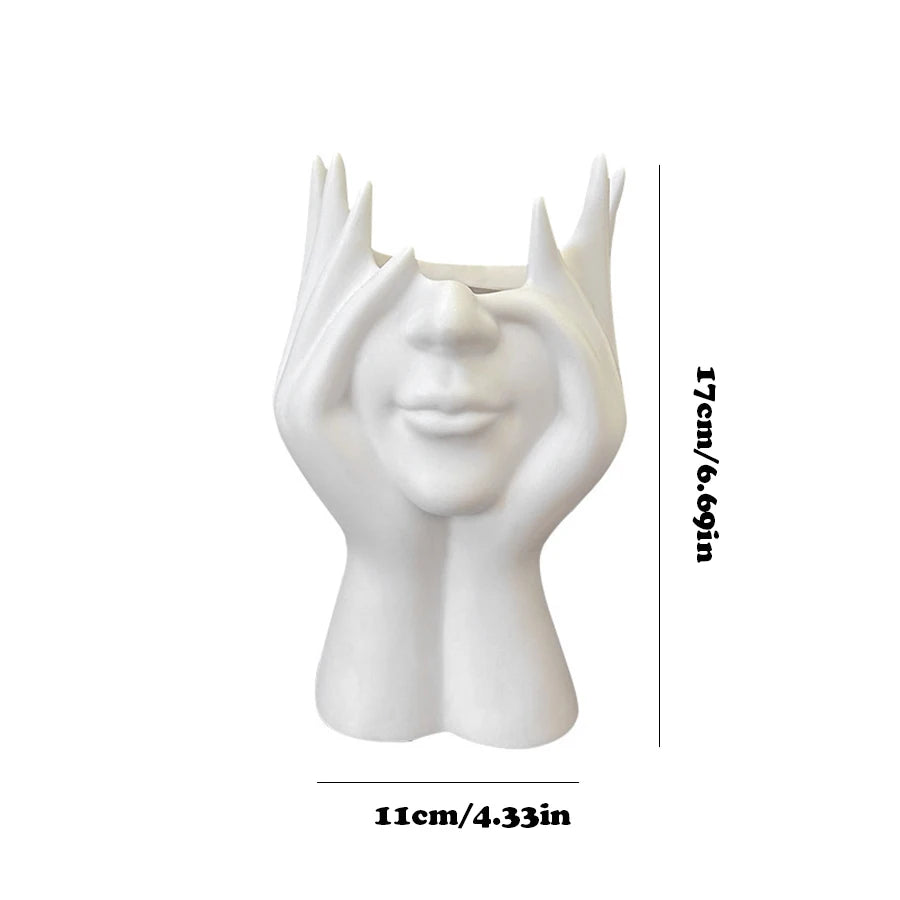 White ceramic vase shaped like a face with measurement details on a white background
