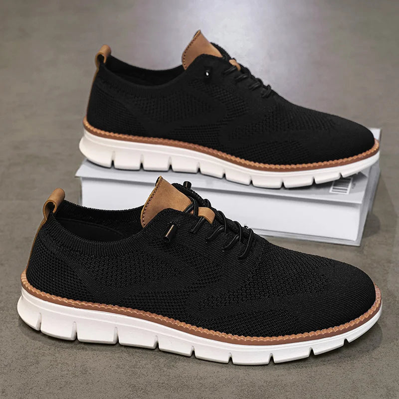 Black sneakers with brown accents on a gray surface