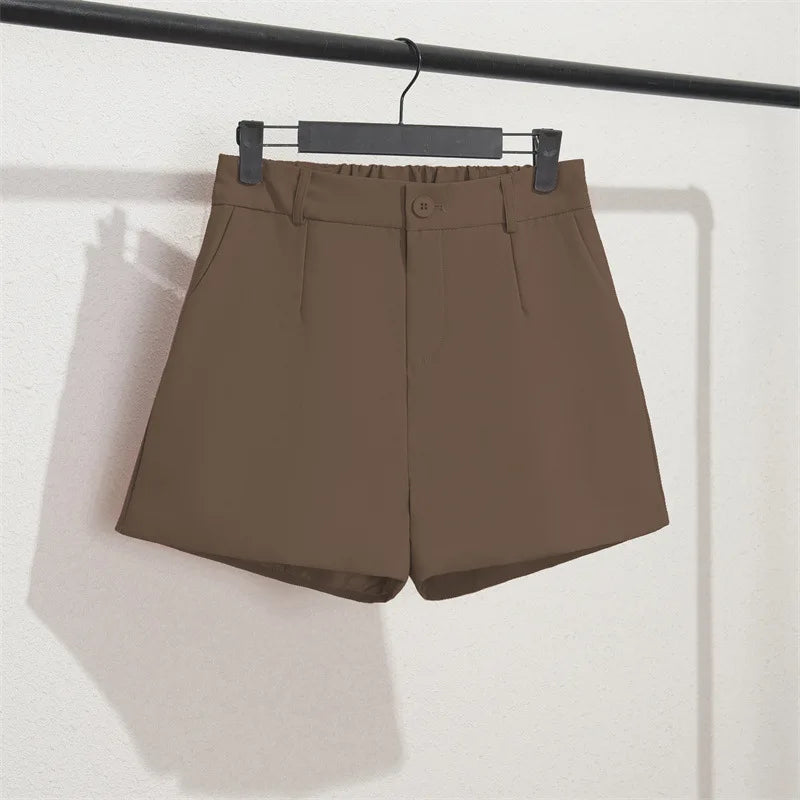 Brown shorts on a hanger against a white background