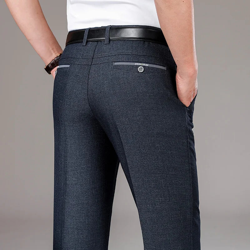 Dark blue pants with a white shirt on a gray background