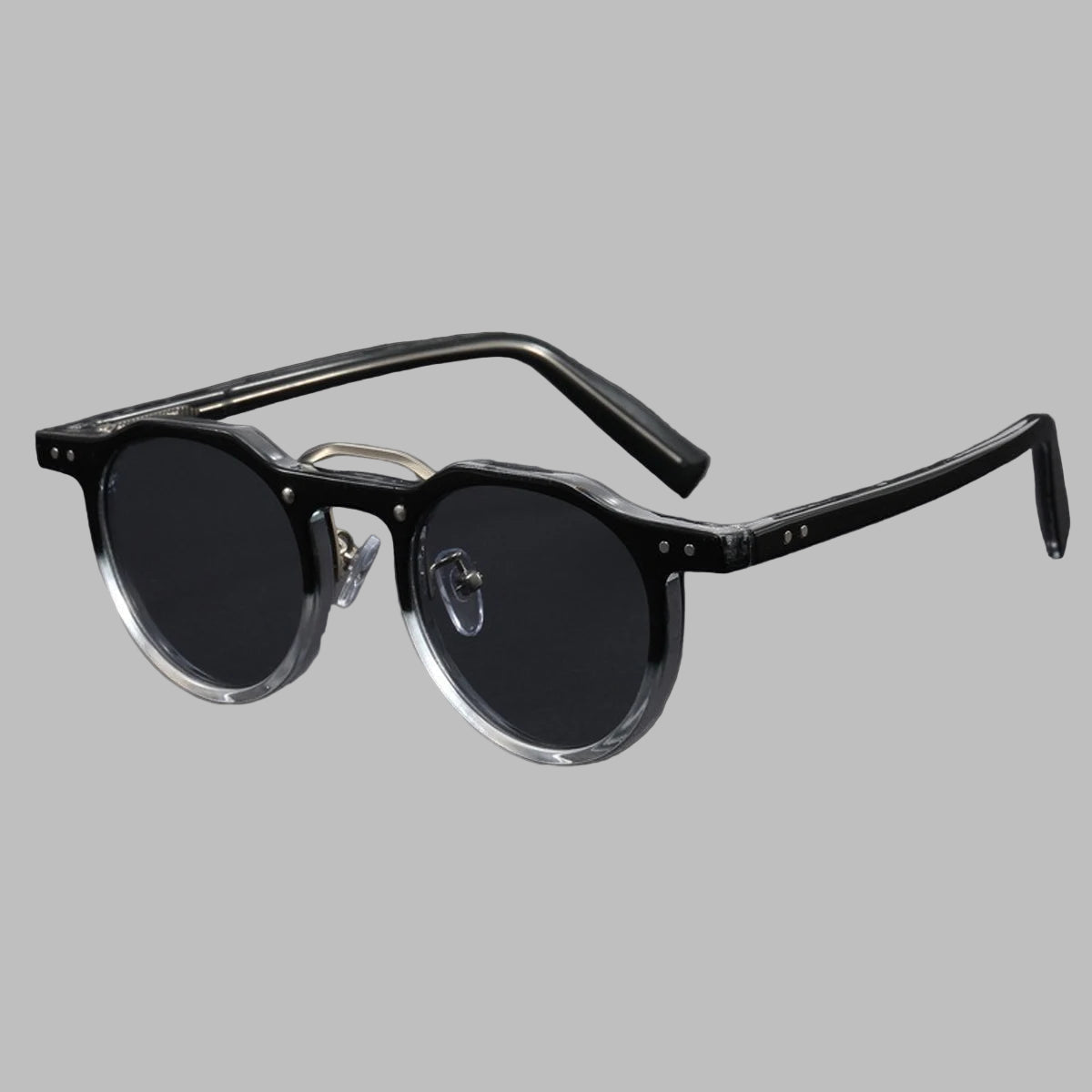 Black sunglasses with clear temple tips on light gray background