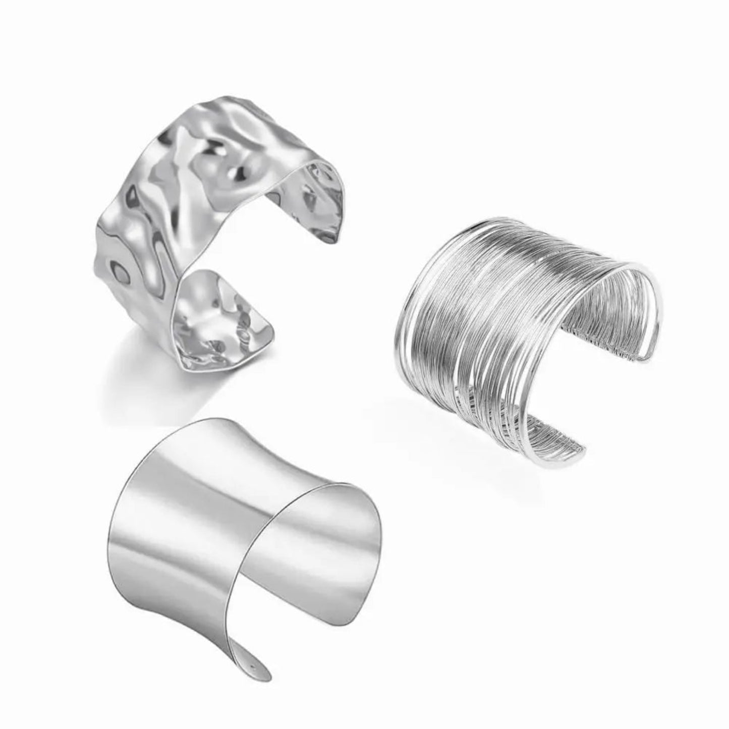Three silver cuff bracelets on a white background