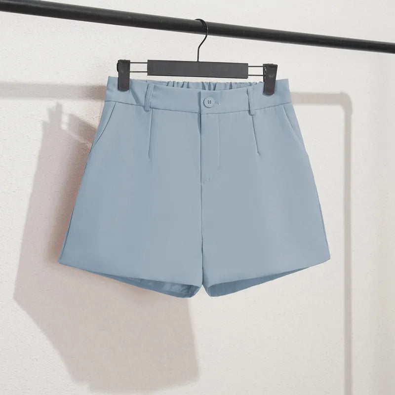 Light blue shorts on a hanger against a white background