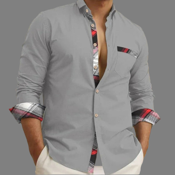 Gray shirt with patterned cuffs and collar worn by a person, indoor setting