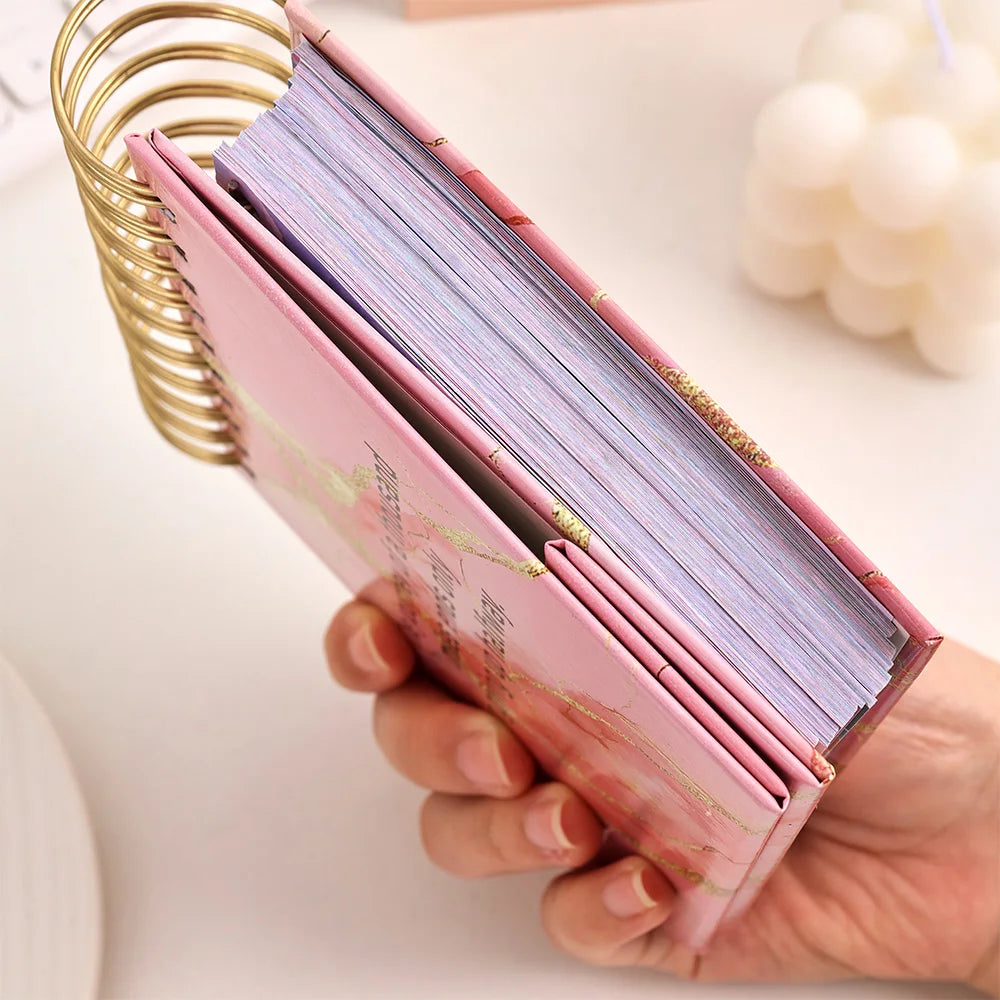 Hand holding a pink card holder with cards inside, on a light background