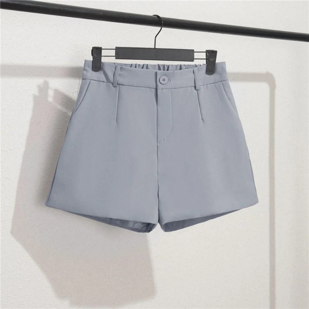 Gray shorts on a hanger against a white background