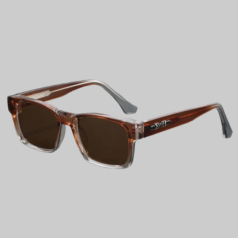 Sunglasses with brown lenses and clear frame on a gray background