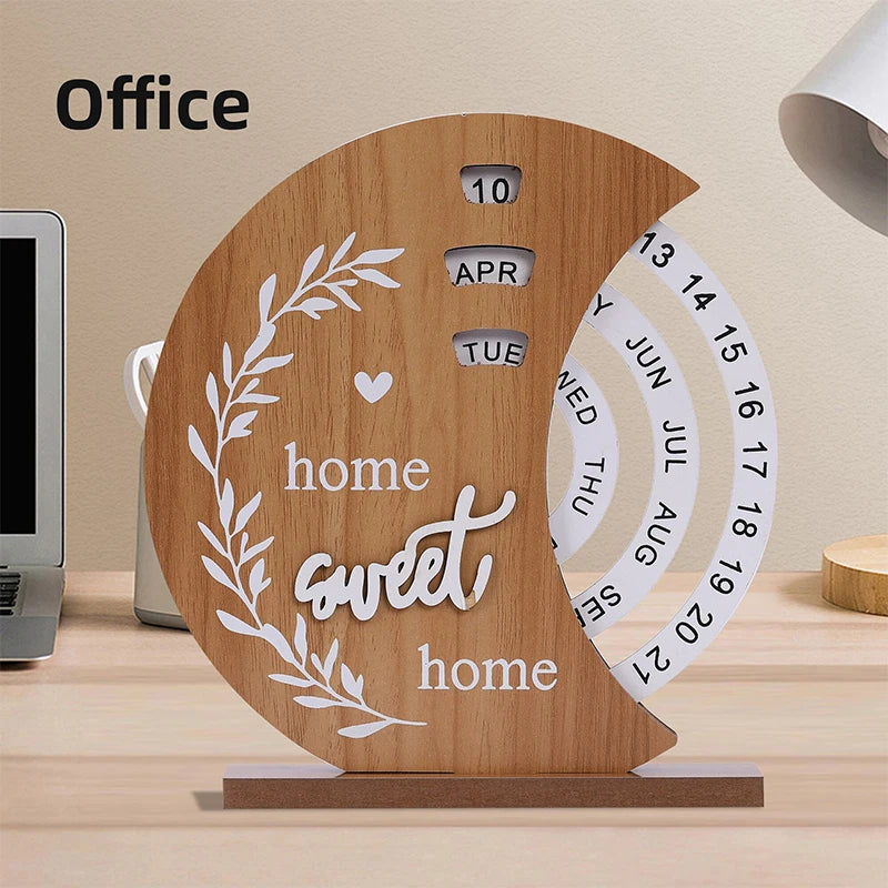 Wooden desk calendar with 'home sweet home' text on a desk.