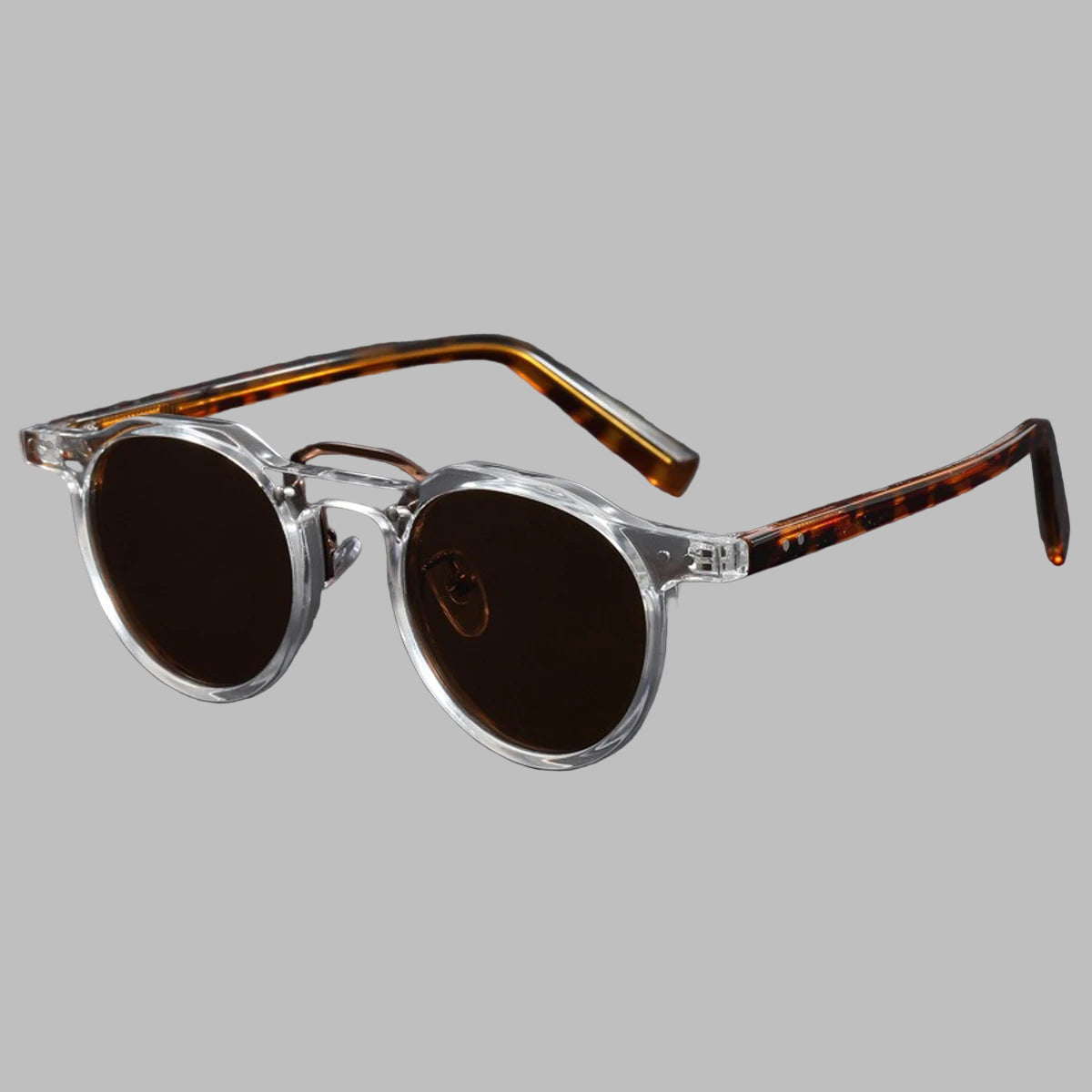 Sunglasses with tortoiseshell frame and dark lenses on a light gray background