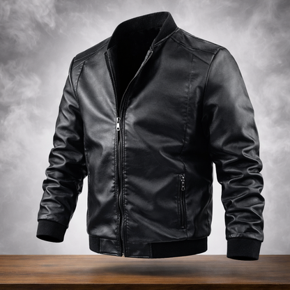 Black leather jacket on a wooden surface with a gray background