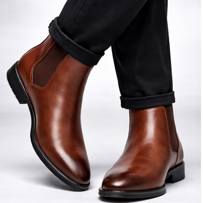 Brown leather boots worn with black pants on a white background