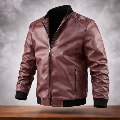 Brown leather jacket with black trim on a wooden surface and gray background