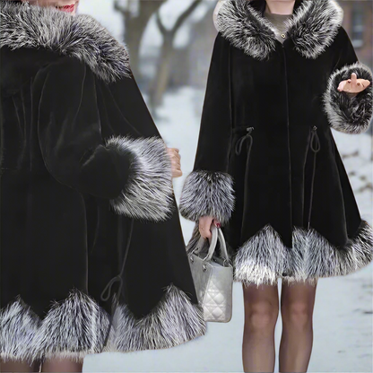 Black coat with fur trim worn by a person in a snowy setting
