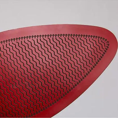 Close-up of a red textured object on a light gray background