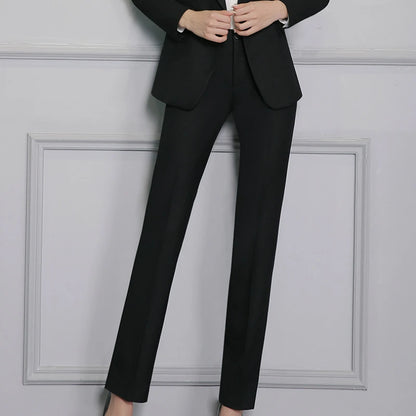 Black suit on a person against a gray wall