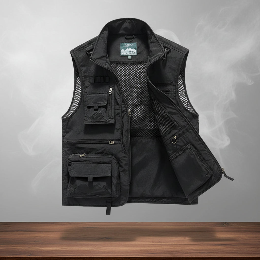 Black tactical vest with multiple pockets on a gray background