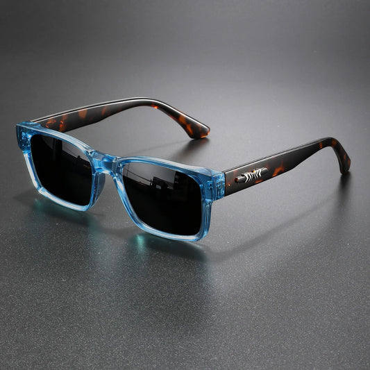 Sunglasses with blue frame and tortoiseshell arms on a gray background