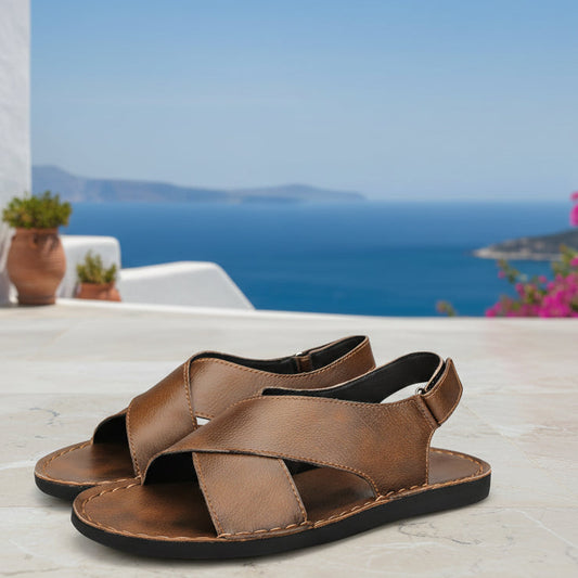 Brown sandals with criss-cross straps on a white background, featuring the Strongshen brand logo.
