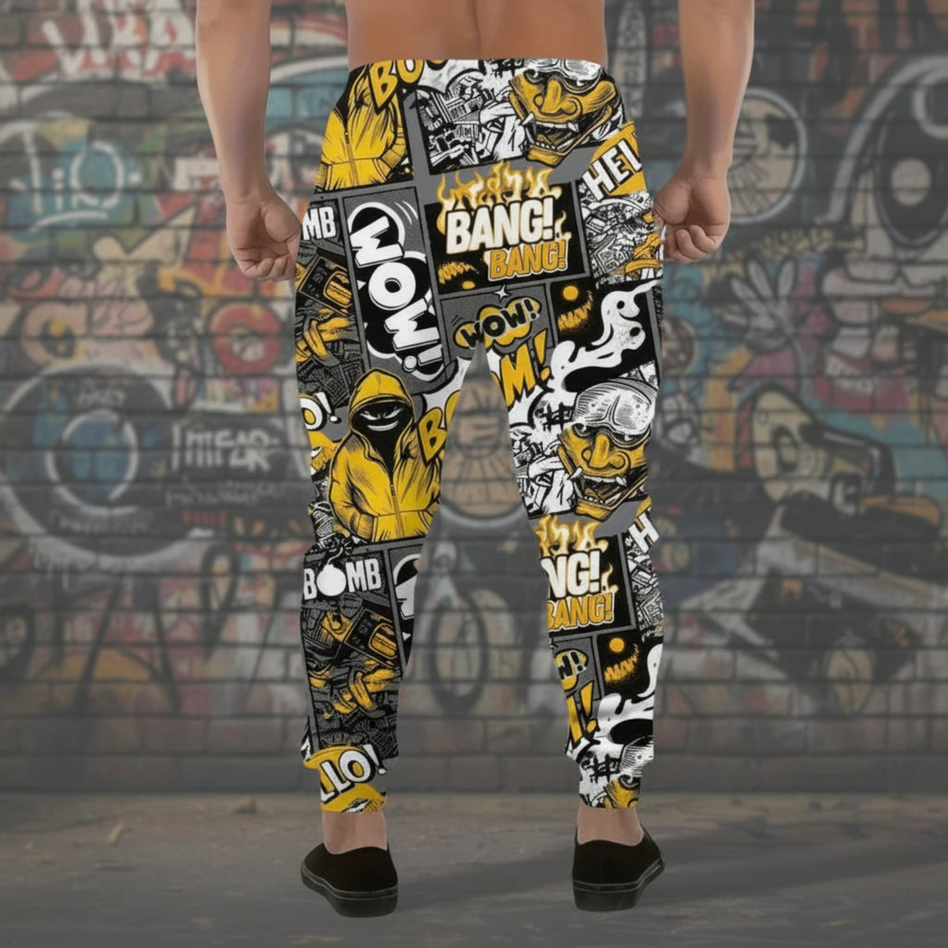 Person wearing a pair of colorful pants with graphic designs against a graffiti-covered wall.