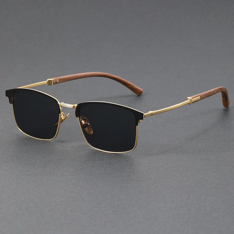 Sunglasses with gold frame and brown accents on a gray background
