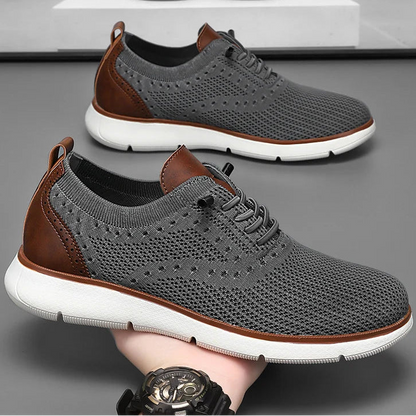 Gray sneakers with brown accents on a gray surface