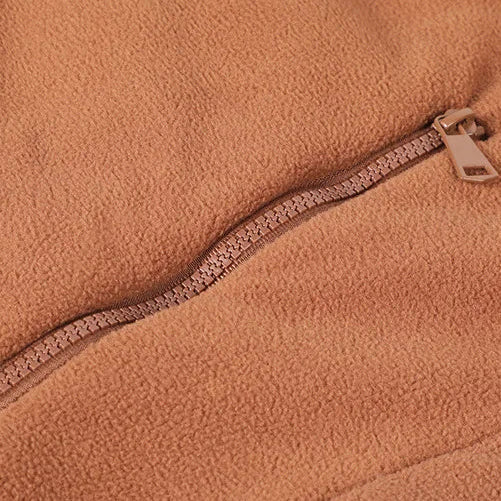 Close-up of a zipper on a brown fleece fabric
