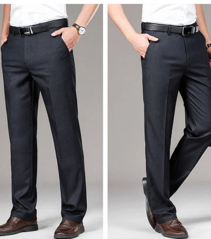 Black dress pants worn by a person on a gray background