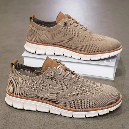 Pair of brown casual shoes with white soles on a gray background