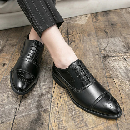Black dress shoes worn on a wooden floor