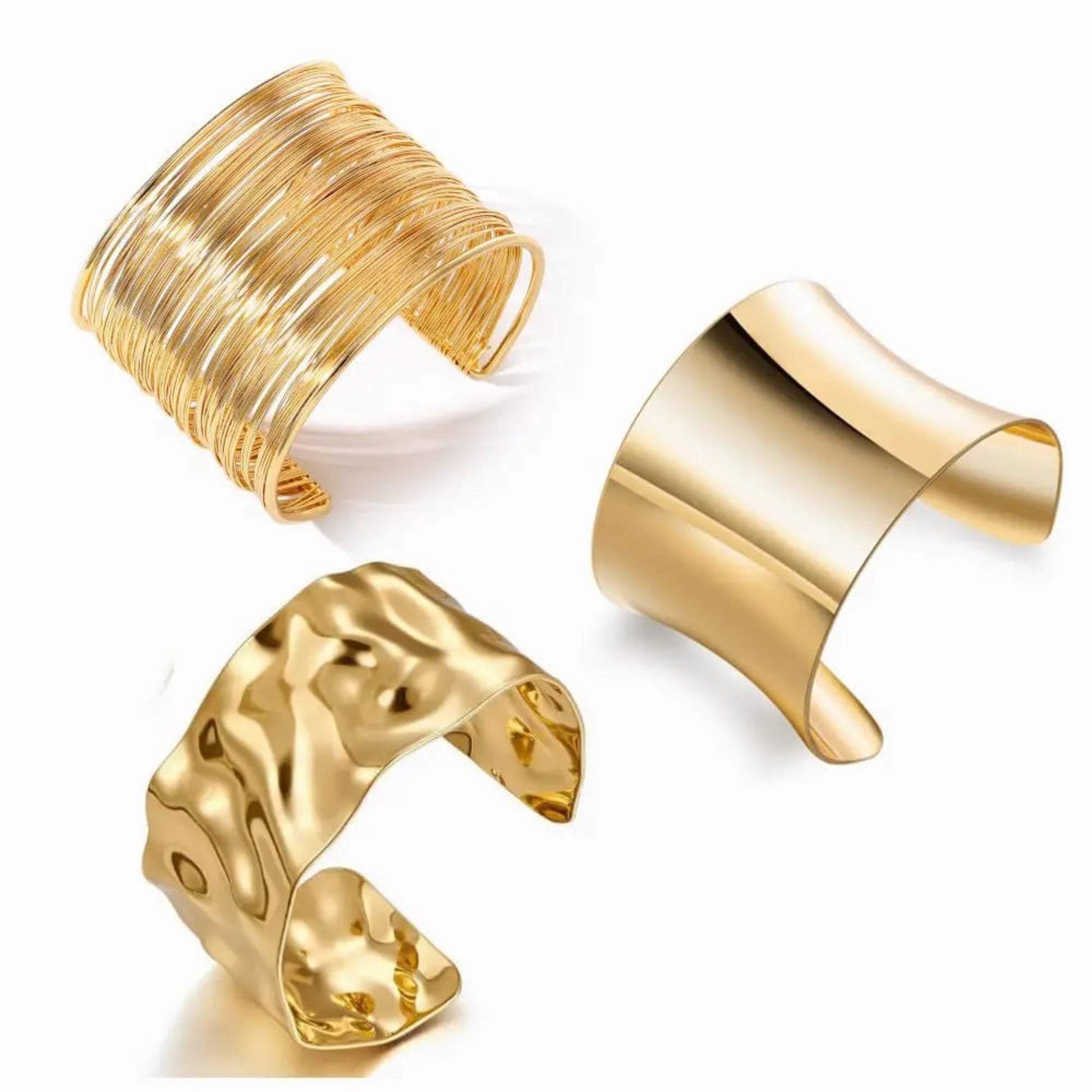 Three gold cuff bracelets on a white background