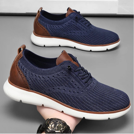 Blue sneakers with brown accents on a gray surface