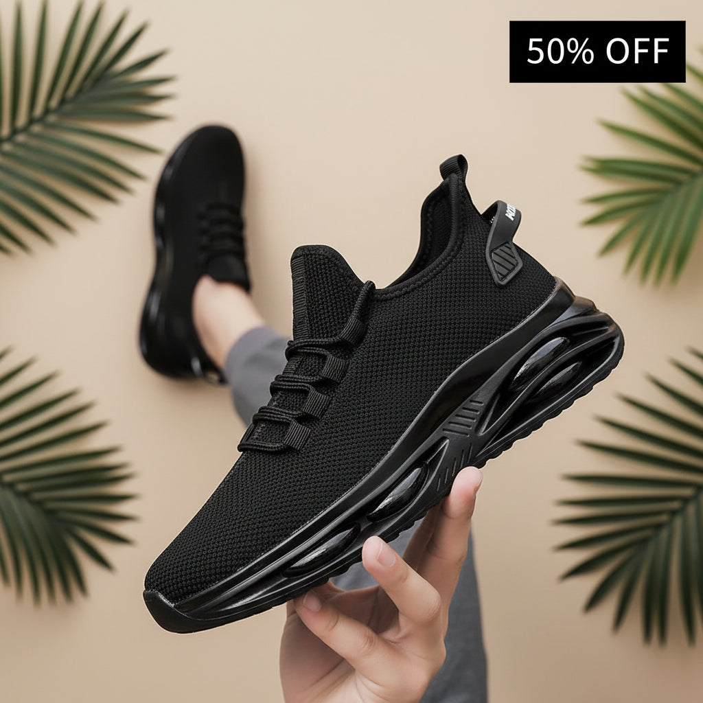Person tying the laces of a black athletic shoe on a blurred street background