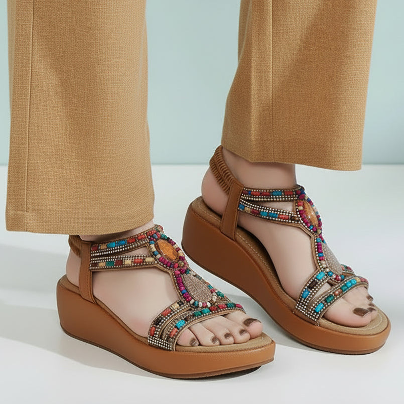 Colorful sandals worn with blue jeans on a light background