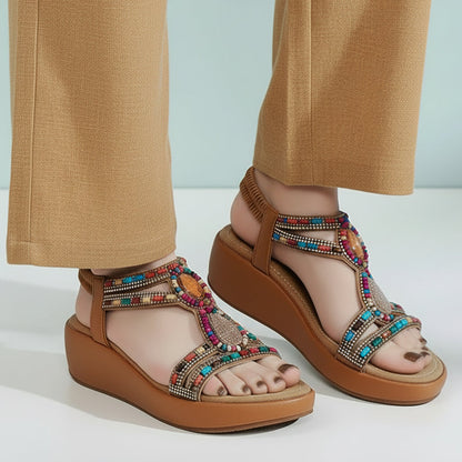 Colorful sandals worn with blue jeans on a light background