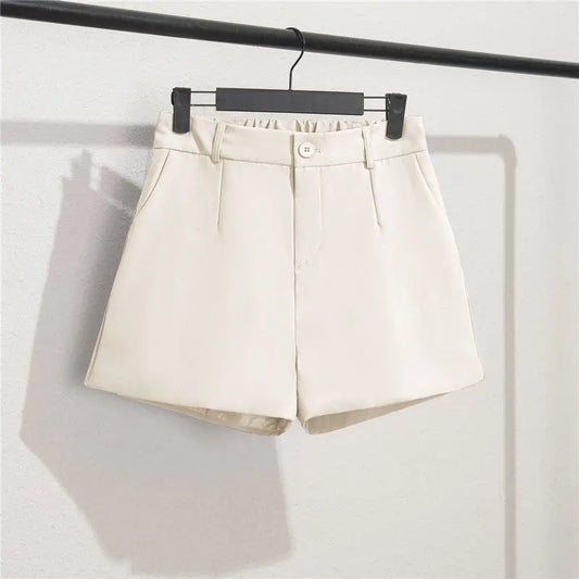Beige shorts hanging on a black hanger against a white background